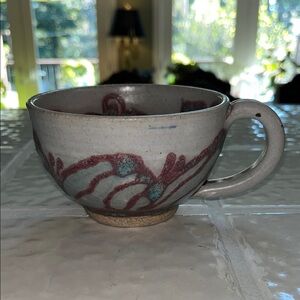 Artisan Ceramic Cup with Red and Blue Accents